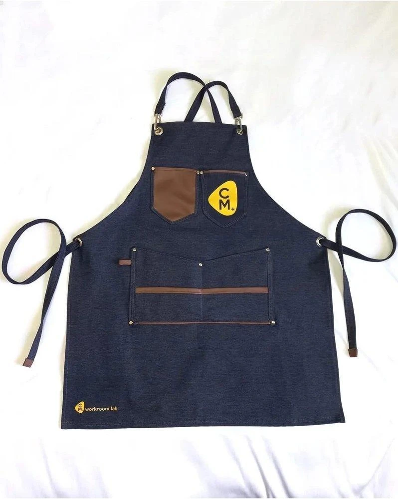 Heavy-duty work apron crafted from ReWeav recycled canvas with leather pockets
