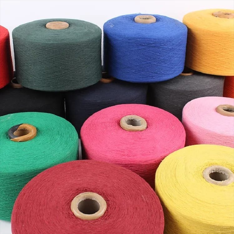 Skilled hands break waste down into fibre and rebuild as yarn