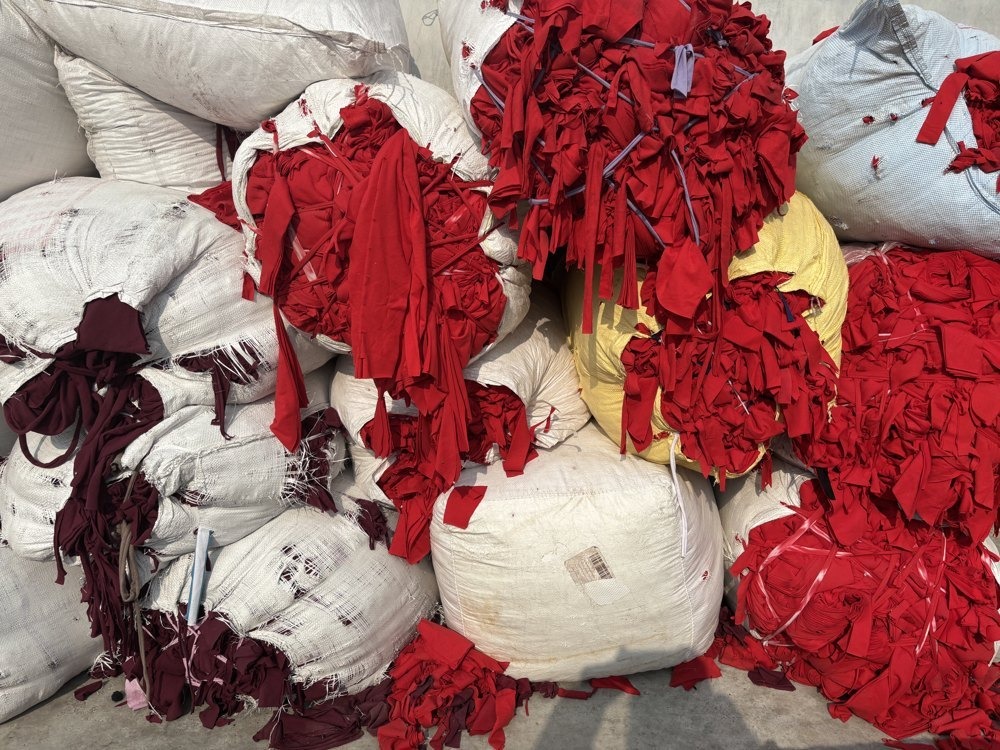Pre-consumer cotton textile waste and post-consumer PET bottles