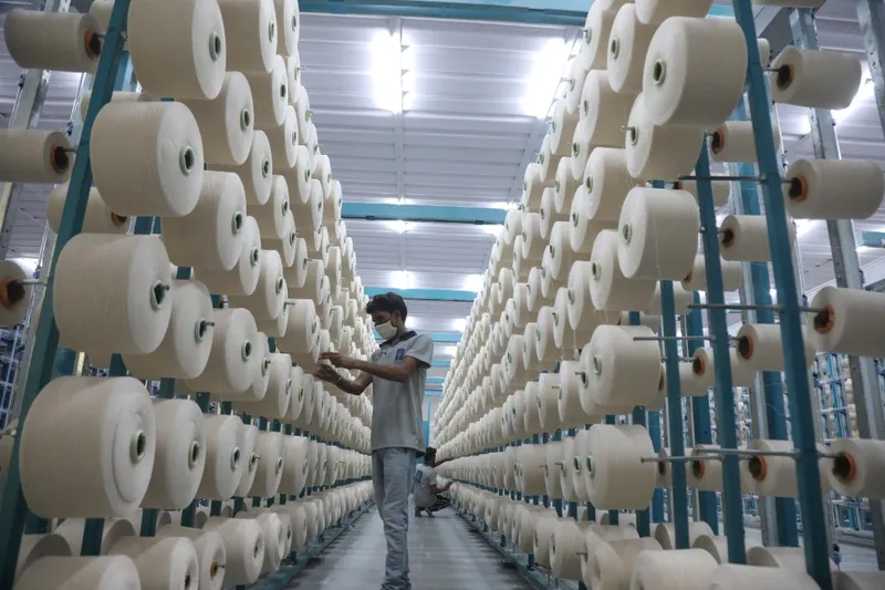 Factory operator at spinning unit